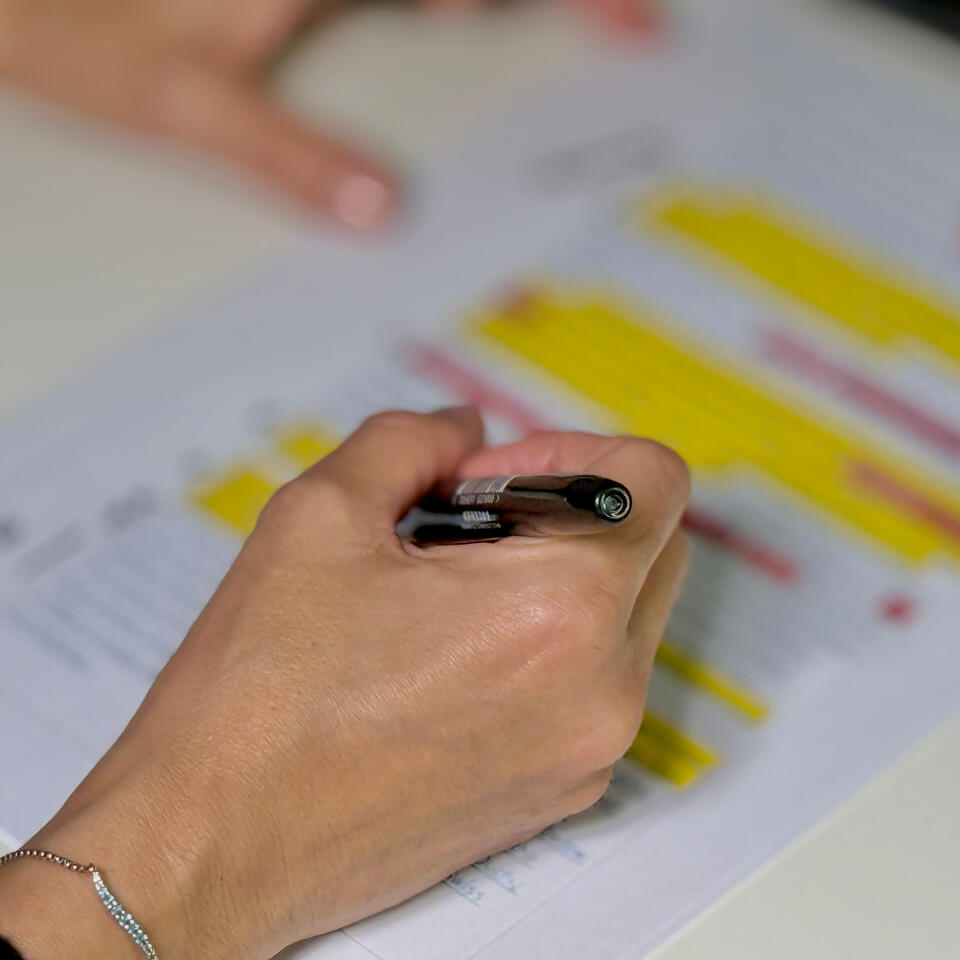 Hand with pen marking up a script